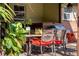 Inviting outdoor patio featuring elegant seating, lush greenery, and a grill, perfect for entertaining at 5011 Dorian Ave, Belle Isle, FL 32812