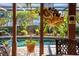 Covered patio overlooking pool with mature foliage and tropical plants at 5011 Dorian Ave, Belle Isle, FL 32812