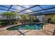 Private screened-in pool area with brick pavers and mature landscaping, perfect for relaxation at 5011 Dorian Ave, Belle Isle, FL 32812