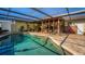 Refreshing swimming pool surrounded by a well-maintained patio and lush, colorful plants at 5011 Dorian Ave, Belle Isle, FL 32812