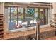 A kitchen window offers a beautiful view of a backyard with a pool, plants and patio furniture at 5011 Dorian Ave, Belle Isle, FL 32812