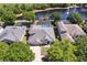 Stunning aerial view of a lakeside home featuring a screened-in pool and lush landscaping at 5619 Bear Stone Run, Oviedo, FL 32765