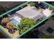 Aerial view of a home with a pool in a screened enclosure and green landscaping at 5619 Bear Stone Run, Oviedo, FL 32765
