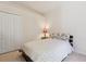 Bedroom with closet, side table, lamp and a window letting in natural light at 5619 Bear Stone Run, Oviedo, FL 32765