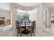 Bright dining area featuring a round table, six chairs, and views of the screened-in pool area at 5619 Bear Stone Run, Oviedo, FL 32765