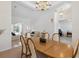 Open floor plan showcasing the dining room with a grand chandelier, adjacent to the living room and entryway at 5619 Bear Stone Run, Oviedo, FL 32765