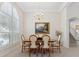 Elegant dining room with natural light, trey ceiling, chandelier, and plantation shutters on arched windows at 5619 Bear Stone Run, Oviedo, FL 32765