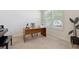 Well-lit home office with a large desk, chair, and a window, ideal for a quiet workspace at 5619 Bear Stone Run, Oviedo, FL 32765