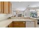 Bright kitchen featuring white countertops, stainless steel appliances, and a cozy breakfast bar at 5619 Bear Stone Run, Oviedo, FL 32765