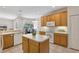 Well-maintained kitchen featuring white appliances, a functional island, and easy access to the dining area at 5619 Bear Stone Run, Oviedo, FL 32765