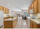 Spacious kitchen with center island, ample storage, and a seamless flow to adjacent dining area at 5619 Bear Stone Run, Oviedo, FL 32765
