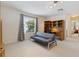 Living room featuring a futon, large window and shelving at 5619 Bear Stone Run, Oviedo, FL 32765