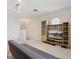 Living room with sofa, TV, shelving and a staircase in the background at 5619 Bear Stone Run, Oviedo, FL 32765