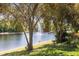 Picturesque view of a community pond with a fountain, lush greenery, and various birds at 5619 Bear Stone Run, Oviedo, FL 32765