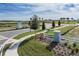 Trinity Lakes entrance with a white fence and landscaping, capturing a welcoming view of the community at 7028 Rolling Leaf Rd, Groveland, FL 34736