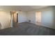 Upstairs hallway with plush gray carpeting, leading to bedrooms and a large walk-in closet at 7028 Rolling Leaf Rd, Groveland, FL 34736