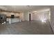 Spacious open-concept living area featuring tile flooring, modern lighting, and ample natural light at 7028 Rolling Leaf Rd, Groveland, FL 34736