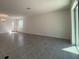 Bright living room with tile flooring and large windows providing plenty of natural light at 7028 Rolling Leaf Rd, Groveland, FL 34736