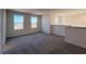 Cozy upstairs loft area with plush carpeting and bright natural light from two large windows at 7028 Rolling Leaf Rd, Groveland, FL 34736
