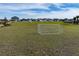 A recreation field with a soccer net in a community, with houses visible in the background at 7028 Rolling Leaf Rd, Groveland, FL 34736