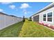 Well-maintained backyard with green lawn, white fence, and screened in lanai at 7369 Sw 77Th Ave, Ocala, FL 34481