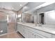 Luxurious bathroom featuring double sinks, white cabinets, and a glass-enclosed shower at 7369 Sw 77Th Ave, Ocala, FL 34481