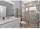 Bathroom featuring a vanity, toilet, and tiled shower with a glass door at 7369 Sw 77Th Ave, Ocala, FL 34481