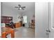 Neutral bedroom featuring wood-style tile floors, a ceiling fan, and natural light at 7369 Sw 77Th Ave, Ocala, FL 34481