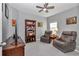 Cozy bedroom featuring two leather recliner chairs, ceiling fan, and a wooden bookshelf at 7369 Sw 77Th Ave, Ocala, FL 34481