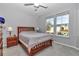 Bright bedroom with windows, a ceiling fan, and a bed with wooden frame at 7369 Sw 77Th Ave, Ocala, FL 34481
