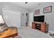 Comfortable bonus room with a TV, storage console, and access to the entryway at 7369 Sw 77Th Ave, Ocala, FL 34481