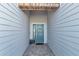 Welcoming light blue front door with brick accents and a charming welcome sign at 7369 Sw 77Th Ave, Ocala, FL 34481