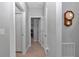 Hallway featuring wood-look tile flooring, doors, and a grandfather clock at 7369 Sw 77Th Ave, Ocala, FL 34481