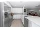 Modern kitchen featuring stainless steel appliances, white cabinetry, and quartz countertops at 7369 Sw 77Th Ave, Ocala, FL 34481