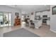Open-concept living area with kitchen, island seating, stainless steel appliances, and sliding glass doors at 7369 Sw 77Th Ave, Ocala, FL 34481