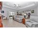 Cozy living room featuring comfortable seating, ceiling fan, and sliding glass doors to the outside at 7369 Sw 77Th Ave, Ocala, FL 34481