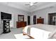 Bright main bedroom featuring a large TV, private access to the back patio, and a walk-in closet at 7369 Sw 77Th Ave, Ocala, FL 34481