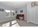 Well-lit home office with wood desk, two windows, and gray tiled floors at 7369 Sw 77Th Ave, Ocala, FL 34481