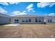 Rear view of a house with a sliding glass door and large windows, set in a spacious yard at 752 Trotters Dr, Eagle Lake, FL 33839