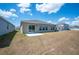 The back of the home shows a sliding glass door and several windows, creating a bright interior at 752 Trotters Dr, Eagle Lake, FL 33839