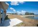 Expansive backyard with a pond view, featuring a small patio, offering a serene outdoor living space at 752 Trotters Dr, Eagle Lake, FL 33839