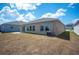 Expansive backyard featuring a sliding glass door and large windows offering ample natural light at 752 Trotters Dr, Eagle Lake, FL 33839