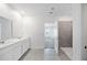 Bright bathroom featuring a double sink vanity and a tiled walk-in shower with modern fixtures at 752 Trotters Dr, Eagle Lake, FL 33839