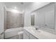Well-lit bathroom featuring a single sink vanity, a large mirror, and a combined bathtub and shower at 752 Trotters Dr, Eagle Lake, FL 33839