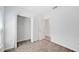 Bright bedroom featuring neutral carpet, open closet, and connecting doorway at 752 Trotters Dr, Eagle Lake, FL 33839