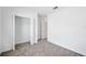 Bright bedroom featuring neutral carpet, open closet, and connecting doorway at 752 Trotters Dr, Eagle Lake, FL 33839
