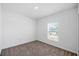 Cozy bedroom with neutral carpet and bright window with blinds overlooking the yard at 752 Trotters Dr, Eagle Lake, FL 33839
