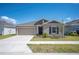 Charming single-Gathering home with a well-manicured lawn and a two-car garage in a quiet neighborhood at 752 Trotters Dr, Eagle Lake, FL 33839