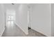 Open hallway view leading to a living area with large windows showcasing lake views, enhancing natural light at 752 Trotters Dr, Eagle Lake, FL 33839