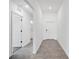 Well-lit hallway with modern fixtures, neutral tones, and tile flooring, creating a welcoming and stylish entrance at 752 Trotters Dr, Eagle Lake, FL 33839